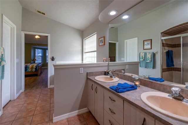 full bathroom with visible vents, a sink, ensuite bath, and tile patterned floors