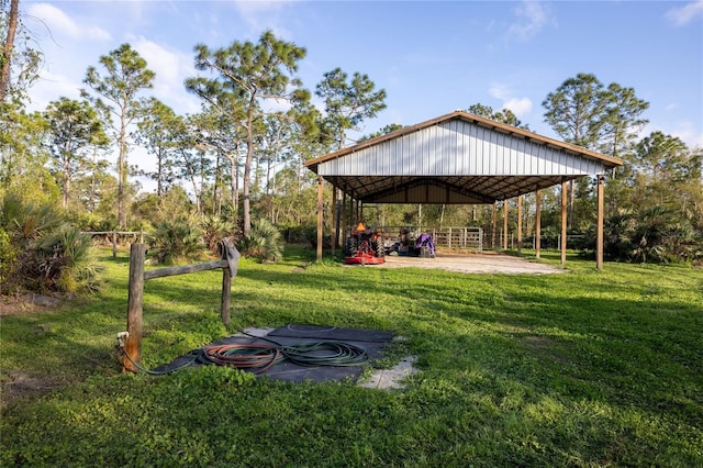 view of yard with driveway and a detached carport