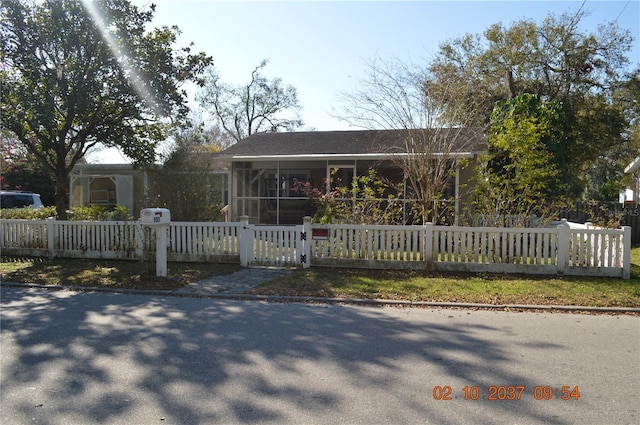 view of front of property featuring a fenced front yard and a gate