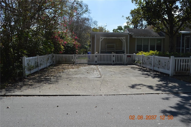 view of gate with a fenced front yard