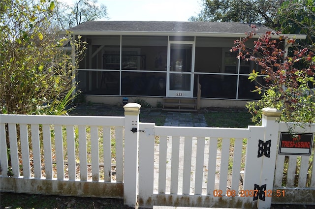 exterior space with a gate, fence private yard, and a sunroom