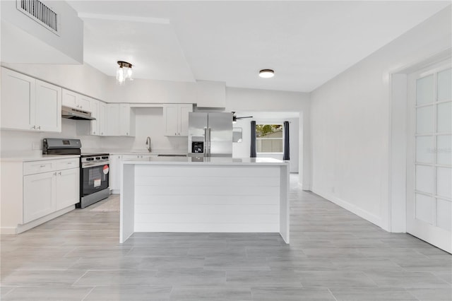 kitchen with under cabinet range hood, stainless steel appliances, a sink, visible vents, and light countertops