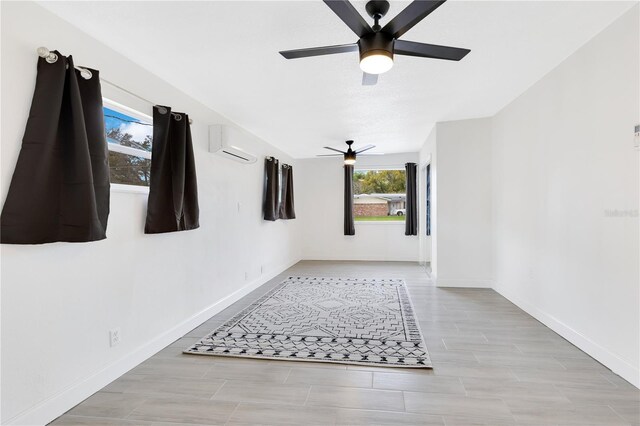 spare room with ceiling fan and baseboards