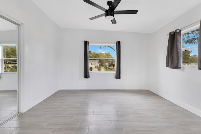 spare room with a healthy amount of sunlight and baseboards