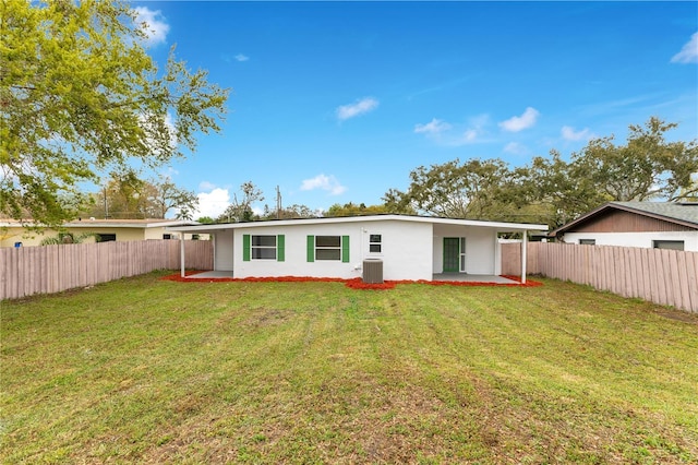 rear view of house with a patio, a lawn, cooling unit, and a fenced backyard