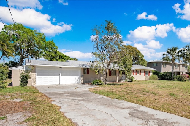 view of front facade featuring a garage, a front yard, and concrete driveway