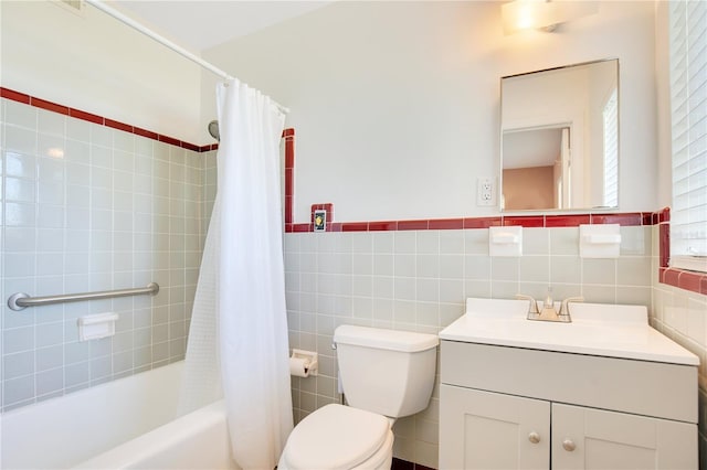 full bath with tile walls, shower / bathtub combination with curtain, toilet, wainscoting, and vanity