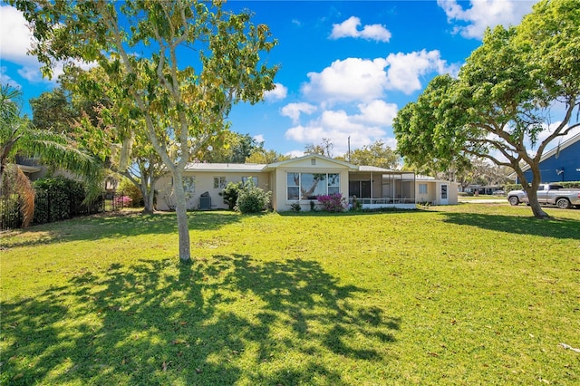 ranch-style home with a front lawn