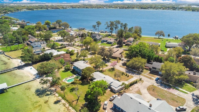 birds eye view of property with a water view and a residential view