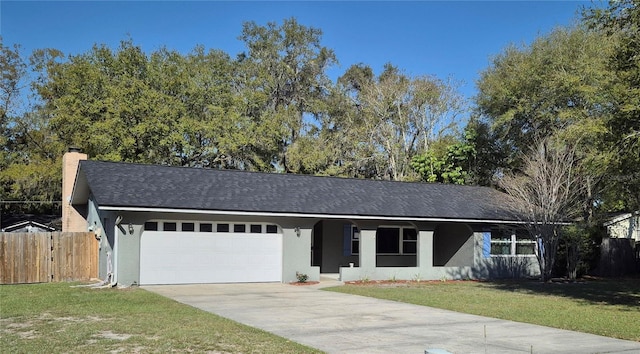 ranch-style house with fence, a front yard, stucco siding, a garage, and driveway