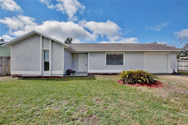 ranch-style house with concrete driveway, a front lawn, an attached garage, and fence