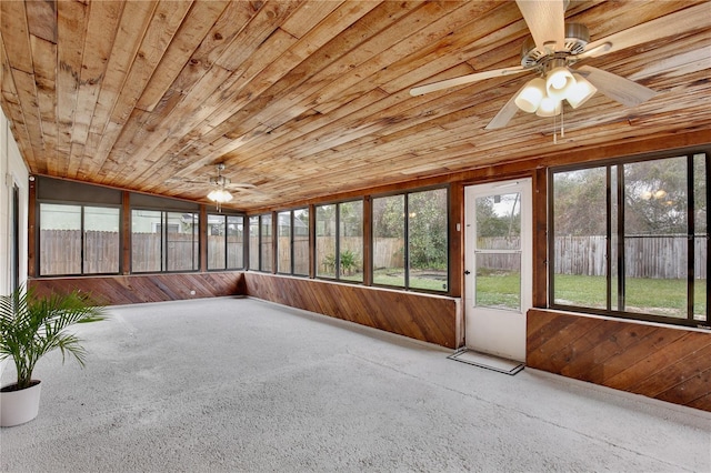 unfurnished sunroom featuring a ceiling fan and wooden ceiling