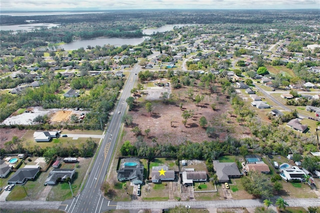 birds eye view of property with a residential view and a water view