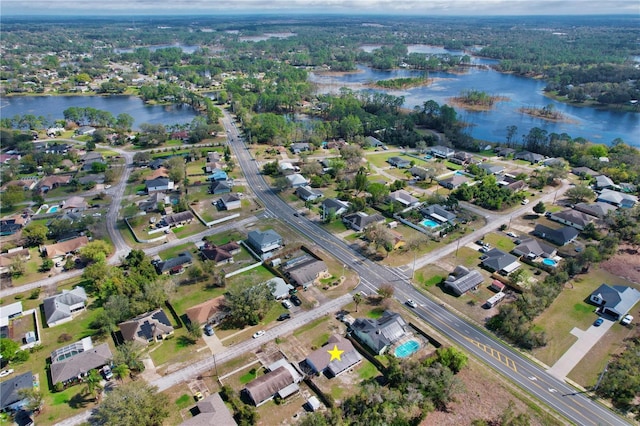 birds eye view of property featuring a water view and a residential view