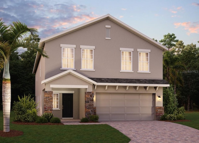 view of front of home with stone siding, decorative driveway, a garage, and stucco siding