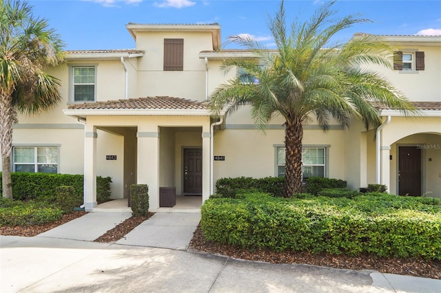 view of front of property featuring a tile roof and stucco siding