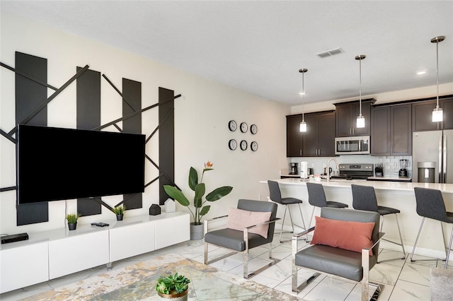 living room with recessed lighting, marble finish floor, visible vents, and baseboards