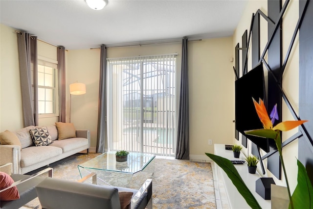 living area with a wealth of natural light and baseboards