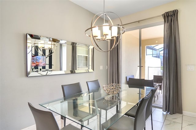 dining space with a chandelier, marble finish floor, and baseboards