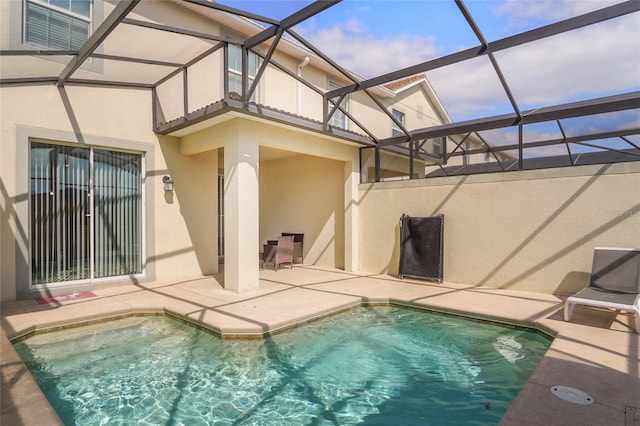 view of swimming pool with a patio area, a lanai, and a fenced in pool
