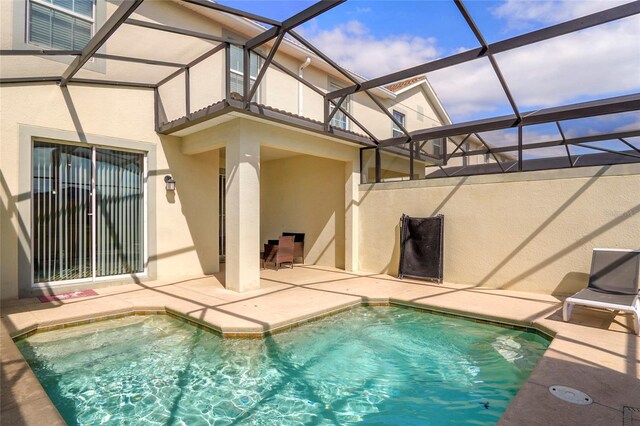 view of pool with a lanai, a fenced in pool, and a patio