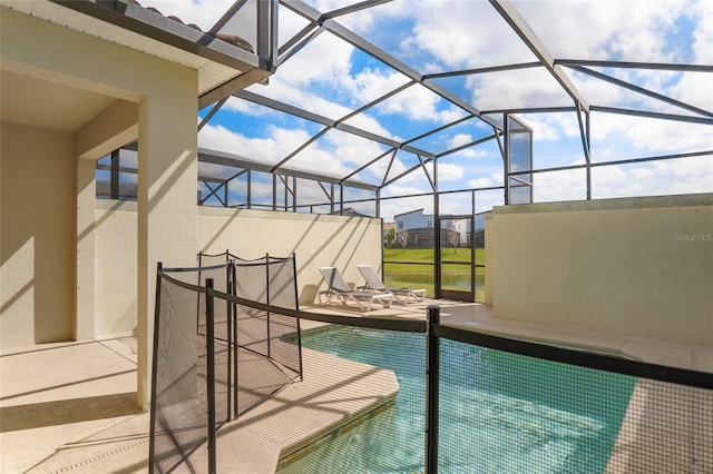 view of swimming pool with a lanai, a patio area, and a swimming pool