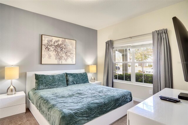 carpeted bedroom with baseboards