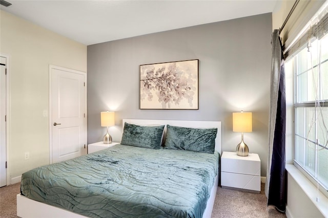 bedroom featuring baseboards and light colored carpet