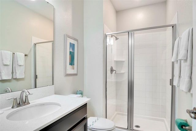 full bathroom with toilet, a shower stall, and vanity