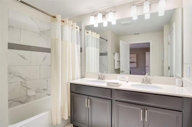 bathroom with double vanity, shower / bathtub combination with curtain, and a sink