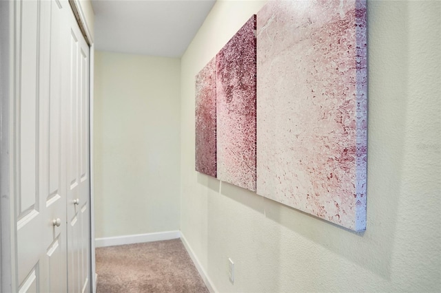 hallway with carpet and baseboards
