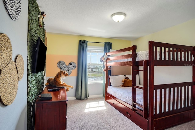 bedroom with a textured ceiling, baseboards, and light colored carpet