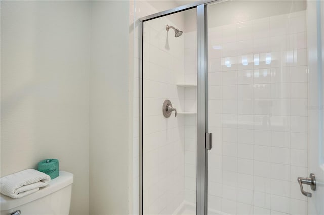 full bath with a stall shower and toilet