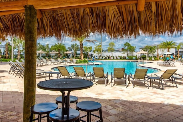 pool with fence and a patio