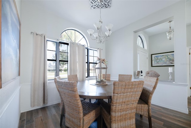 dining area with an inviting chandelier, baseboards, and dark wood finished floors