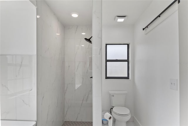 full bath featuring a marble finish shower and toilet