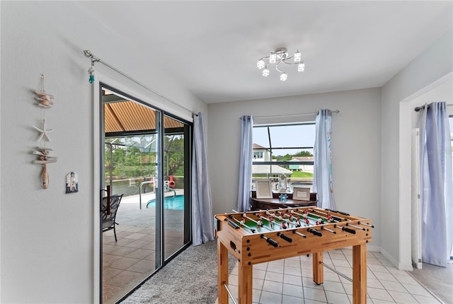 recreation room with light tile patterned floors and baseboards