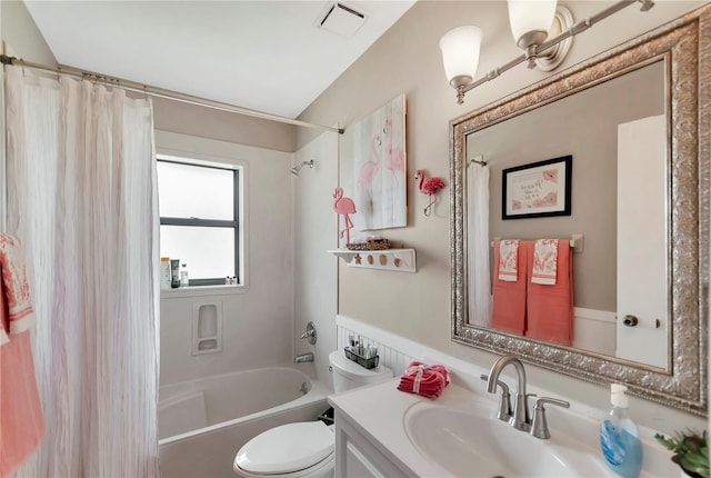 bathroom featuring toilet, vanity, visible vents, and shower / tub combo with curtain