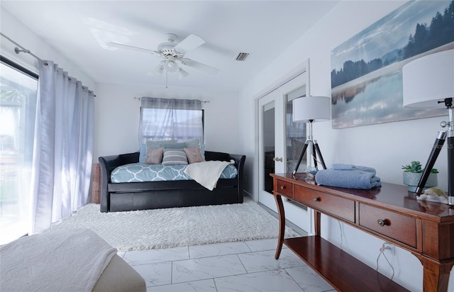 bedroom featuring marble finish floor, ceiling fan, and visible vents