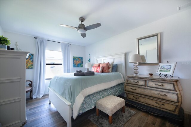 bedroom with a ceiling fan, dark wood-style flooring, and visible vents