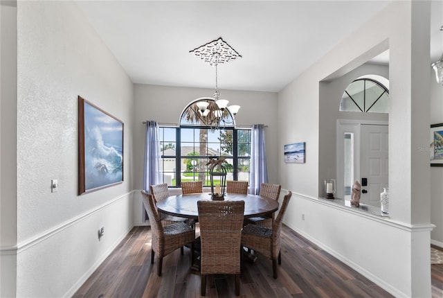 dining room featuring an inviting chandelier, baseboards, and dark wood-type flooring