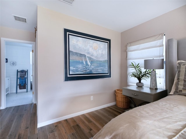 bedroom featuring dark wood-type flooring, visible vents, and baseboards