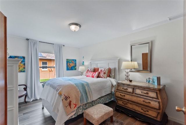 bedroom featuring visible vents and dark wood-type flooring