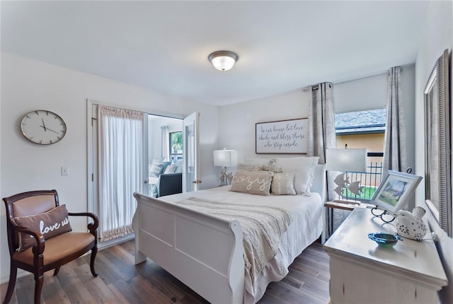 bedroom featuring access to exterior and dark wood-style flooring