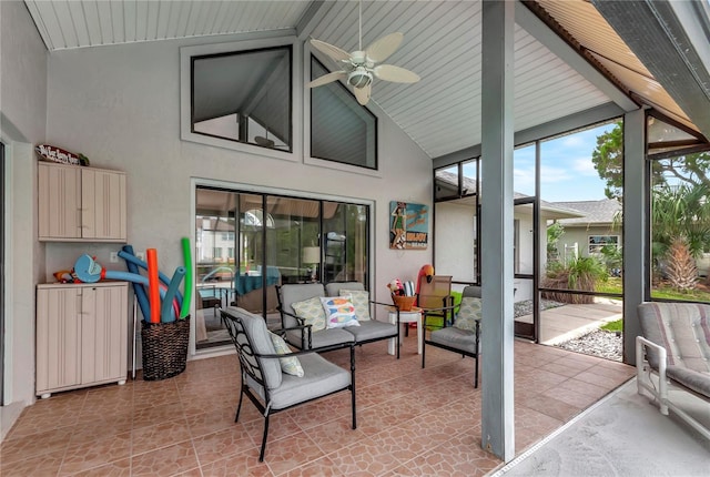 sunroom with vaulted ceiling with beams and ceiling fan