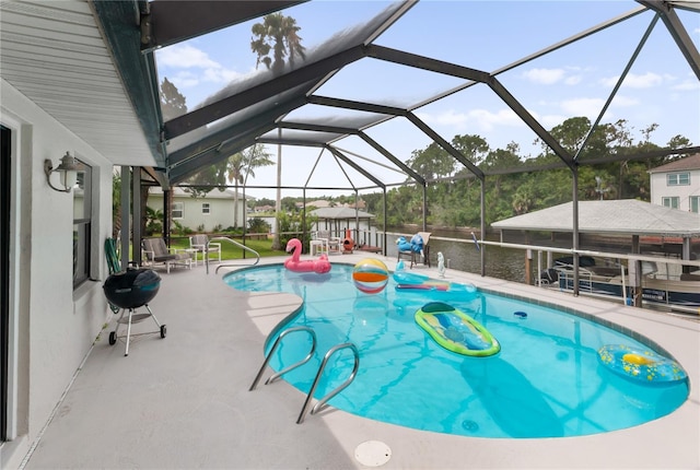 outdoor pool with a patio area, a lanai, and a grill