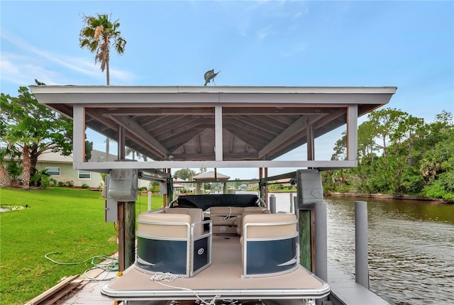 dock area with a lawn, a water view, and boat lift