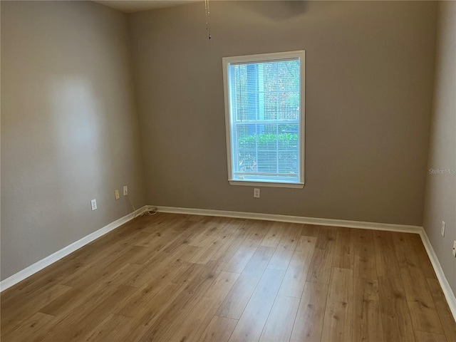 empty room with light wood-style flooring and baseboards