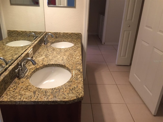 full bath featuring double vanity, a sink, and tile patterned floors