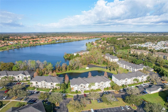 drone / aerial view with a water view and a residential view